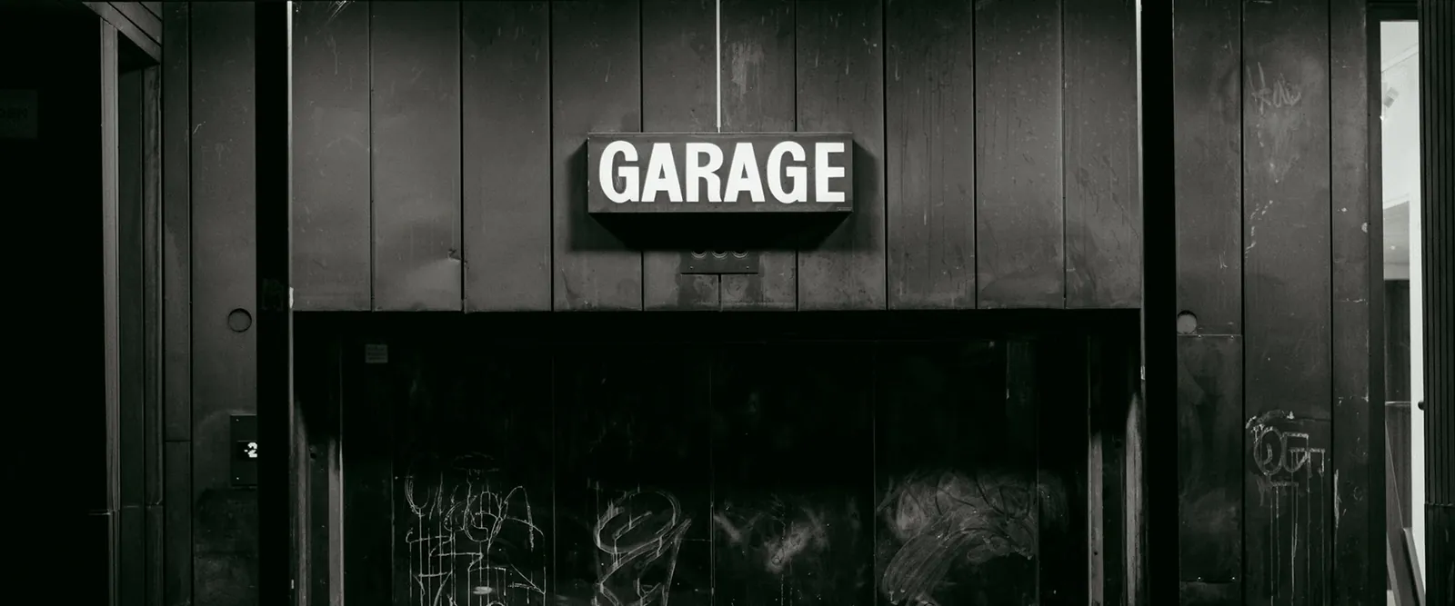 Garage façade with a bold illuminated sign